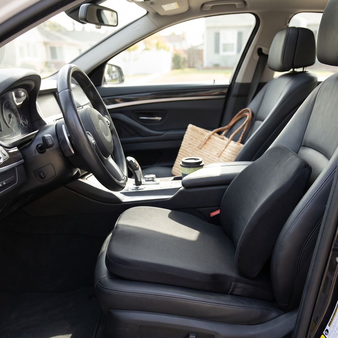 Black memory foam seat and lumbar cushion set installed on a car driver seat