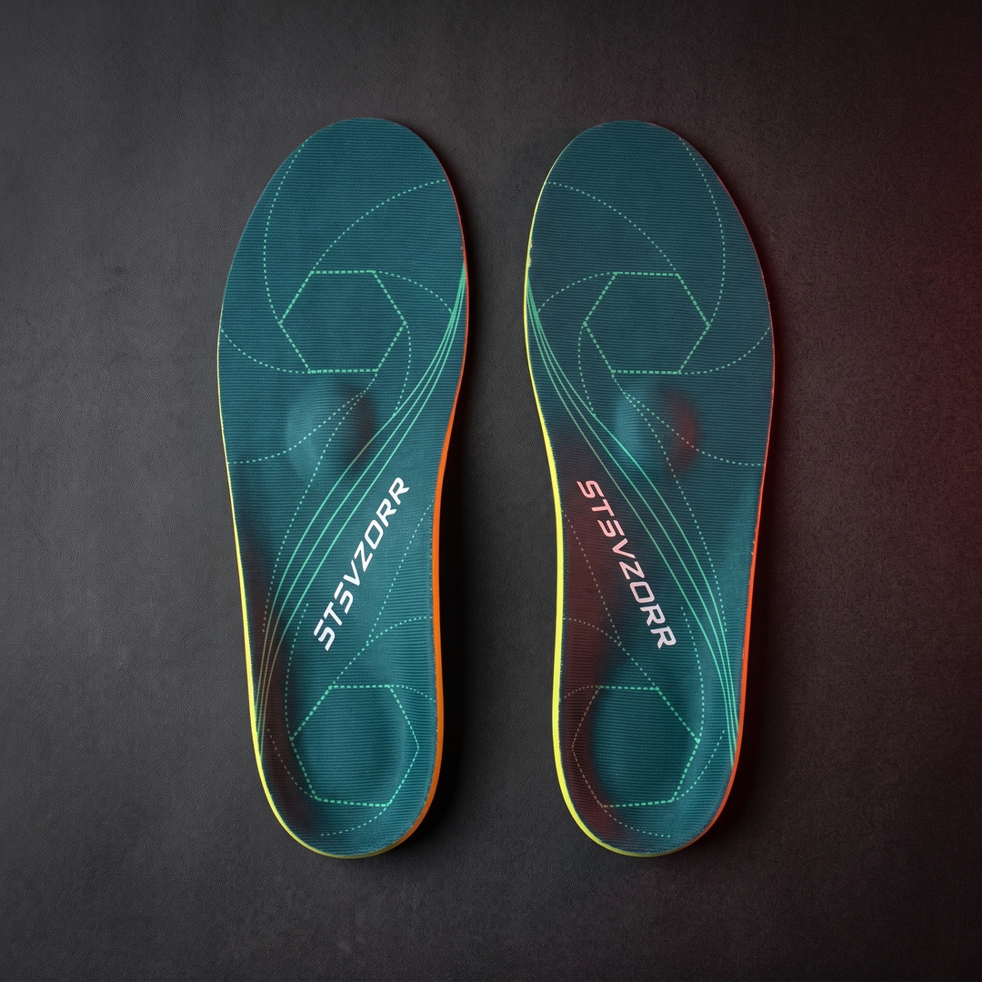 Pair of orthopedic arch support shoe insoles, classic green, flat lay view