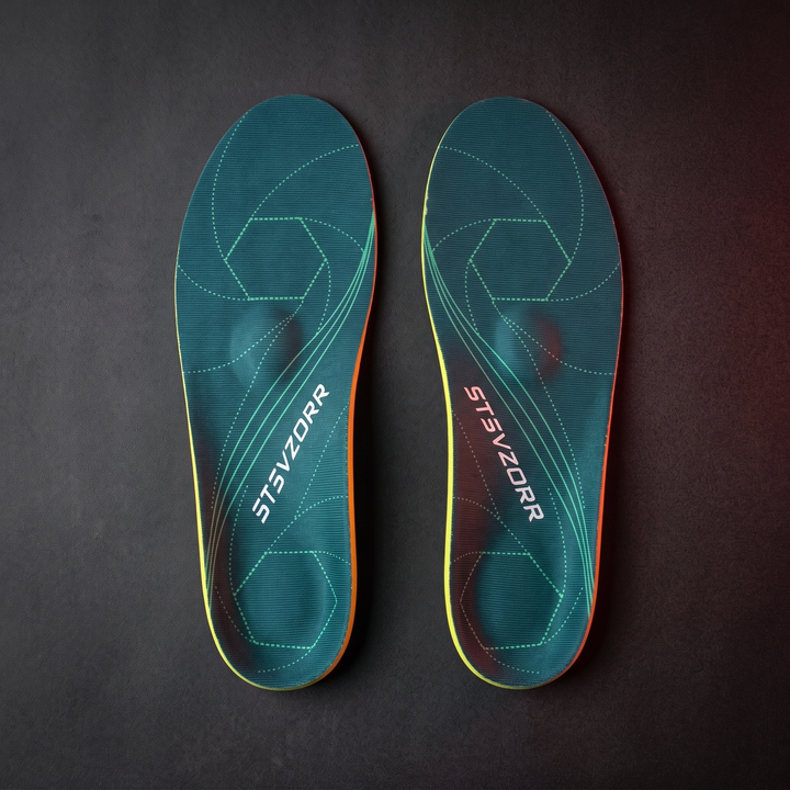 Pair of orthopedic arch support shoe insoles, classic green, flat lay view