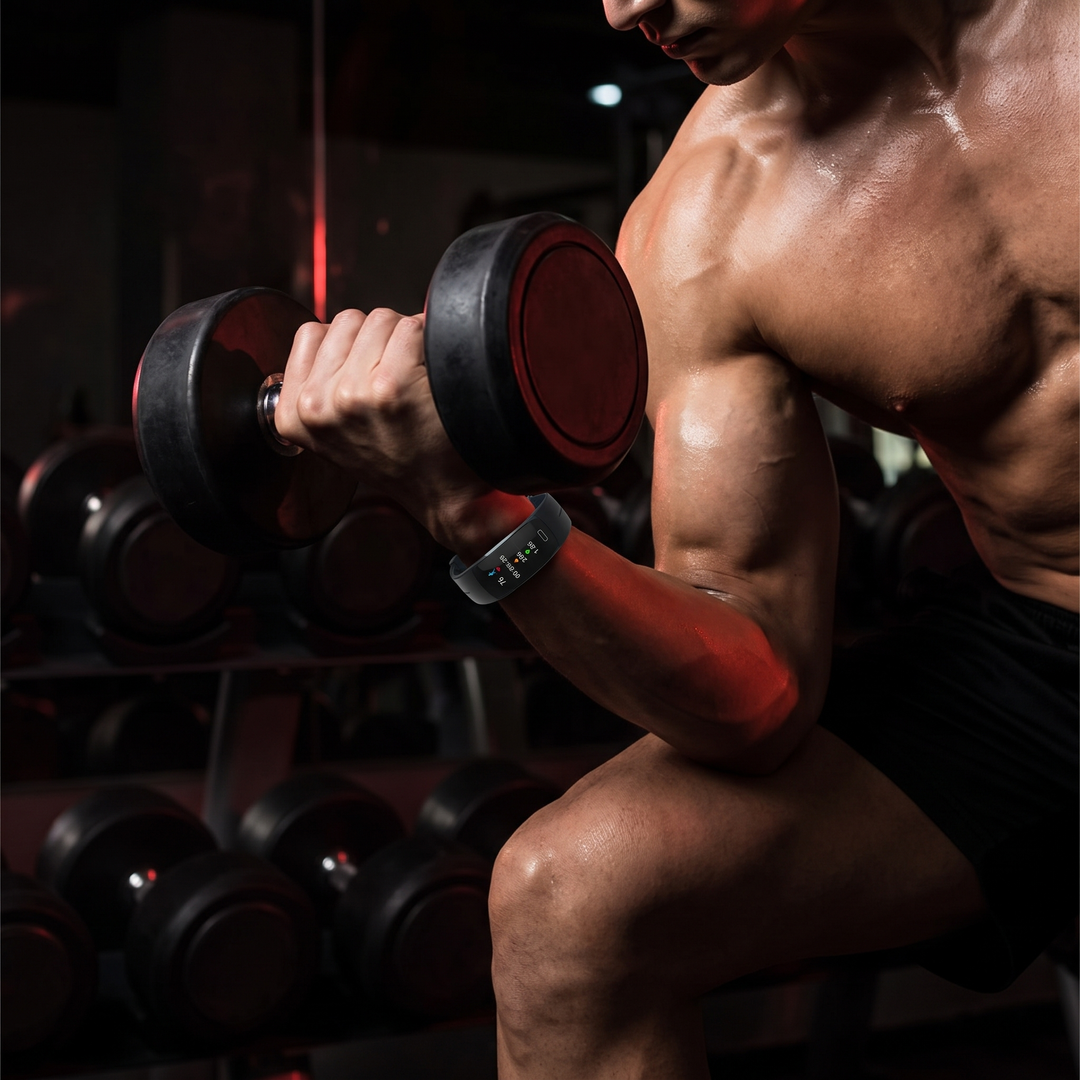 Gym workout wearing a smart fitness band activity tracker on wrist