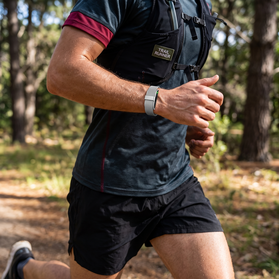 Smart Fitness Tracker Wristband worn while running, silver