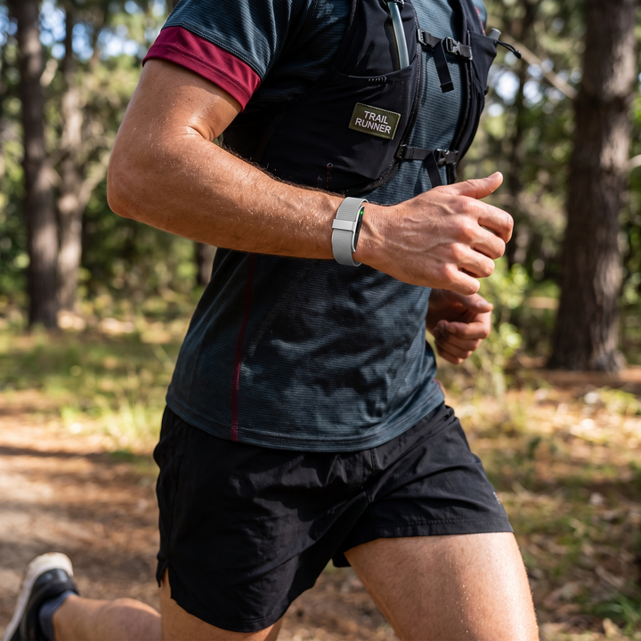 Smart Fitness Tracker Wristband worn while running, silver