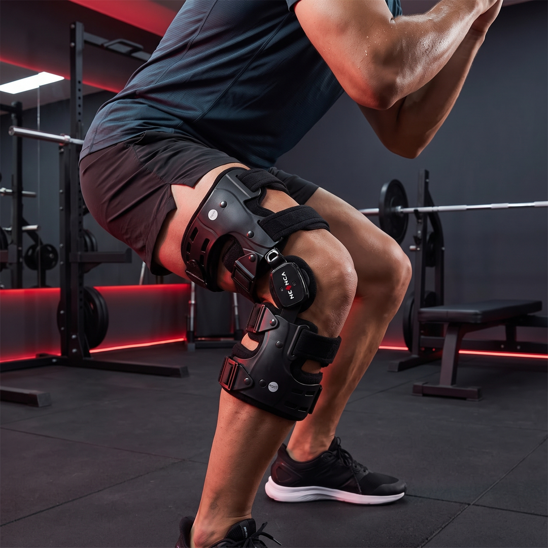 Athlete wearing knee brace during squat training in home gym