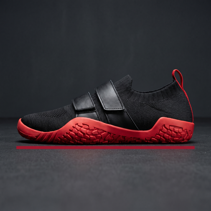 Side profile view of hard sole weightlifting shoe with hook-and-loop strap