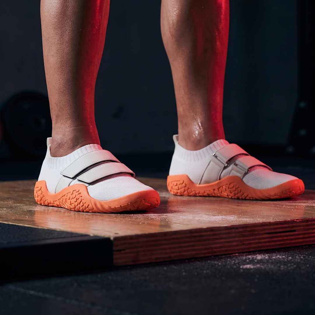 Feet planted firmly on lifting platform in training shoes