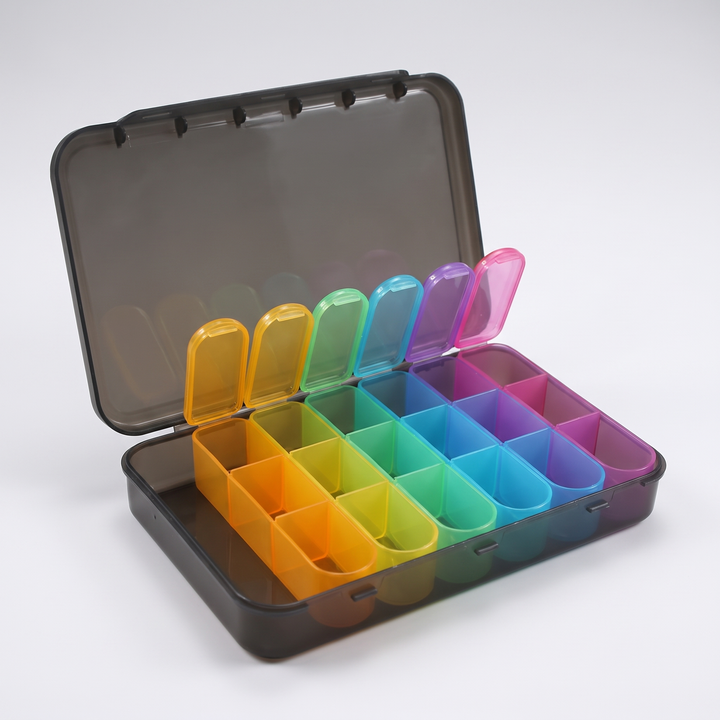 Weekly pill organizer with all 21 compartments open, empty compartment view