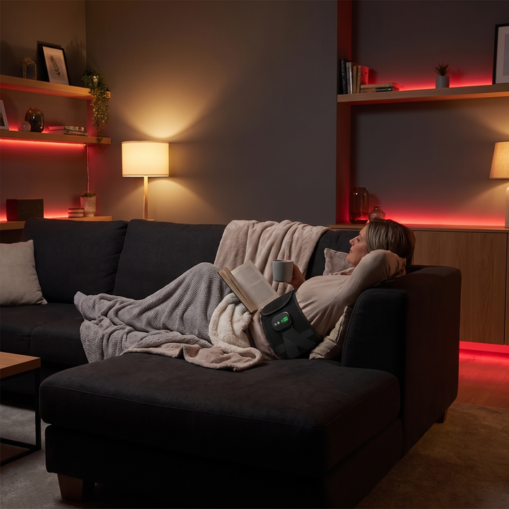 Heated waist support belt evening relaxation on couch lifestyle
