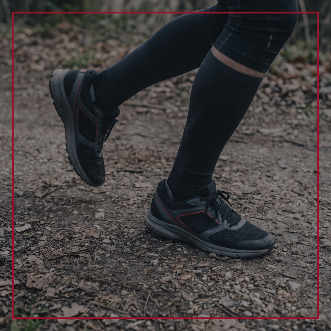 Walking outdoors wearing shoes fitted with arch support insoles