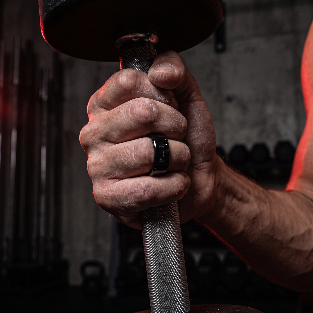Smart Ring Health Monitor Fitness Tracker Ceramic Ring - Gym Dumbbell Grip Lifestyle Shot - Black, Sizes 8-13