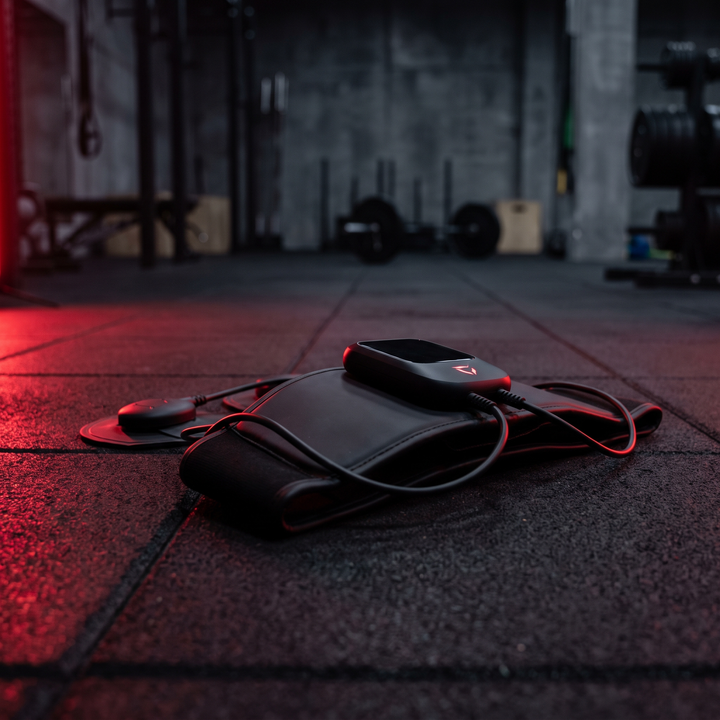 EMS Muscle Stimulation Device in Home Gym Setting