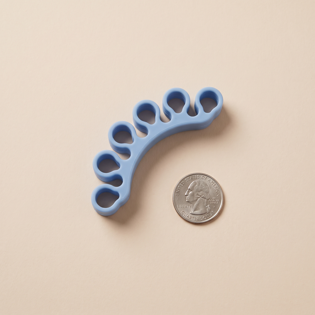 Silicone Toe Spacer Size Reference Next to Coin