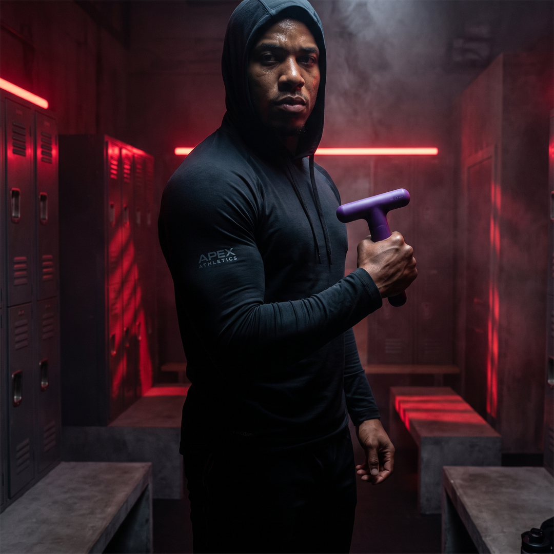Athlete Holding Purple Trigger Point Massage Tool in Gym