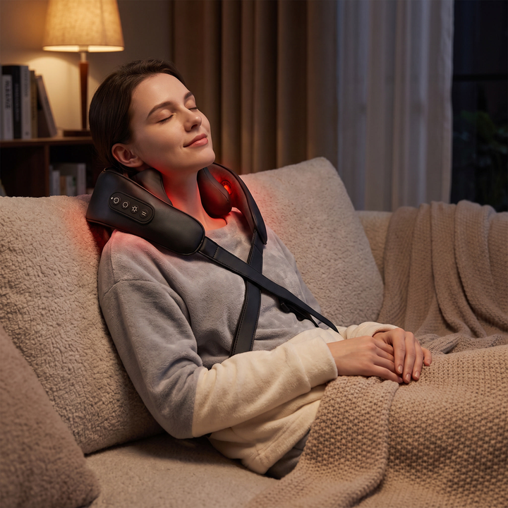 Person relaxing at home in the evening wearing the neck and shoulder pulse massager to unwind