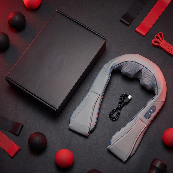 Flat lay of neck and shoulder massager packaging with device and charging cable
