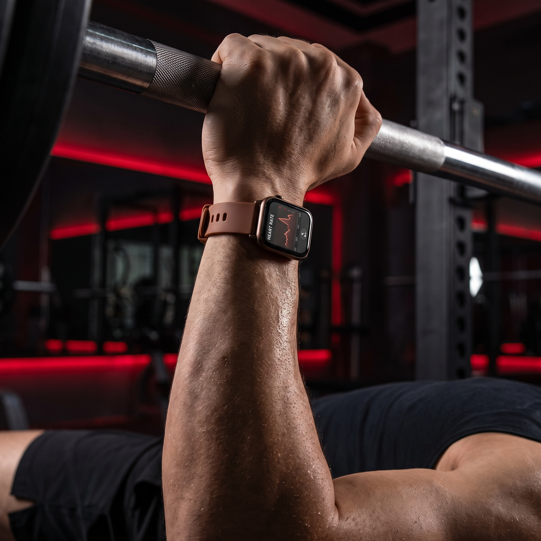 PHYSIOATHLETX smart fitness watch worn during a bench press, brown silicone band