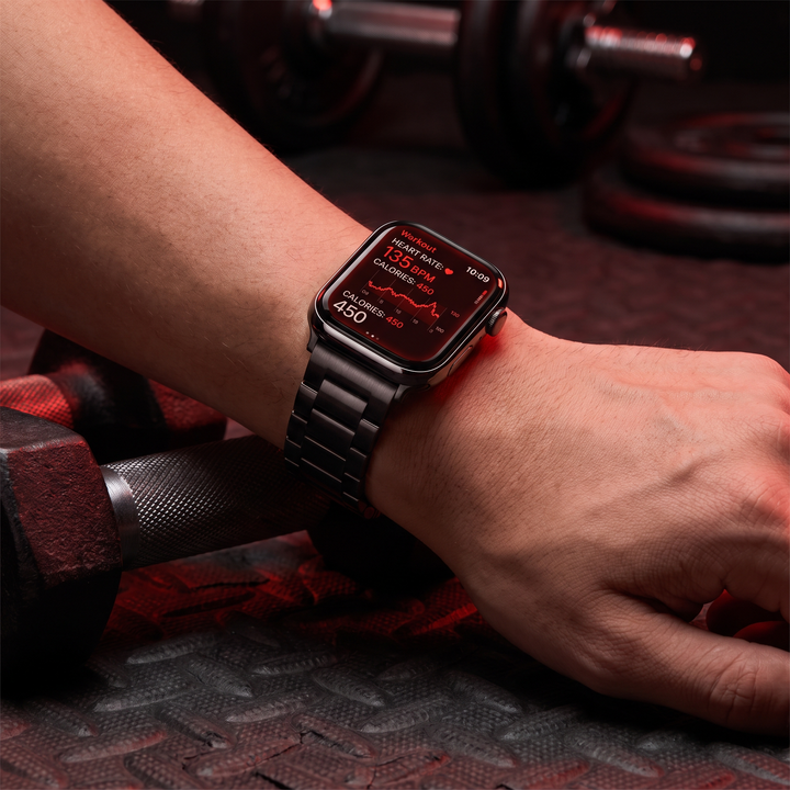 PHYSIOATHLETX smart fitness watch worn on wrist close-up, black steel link band