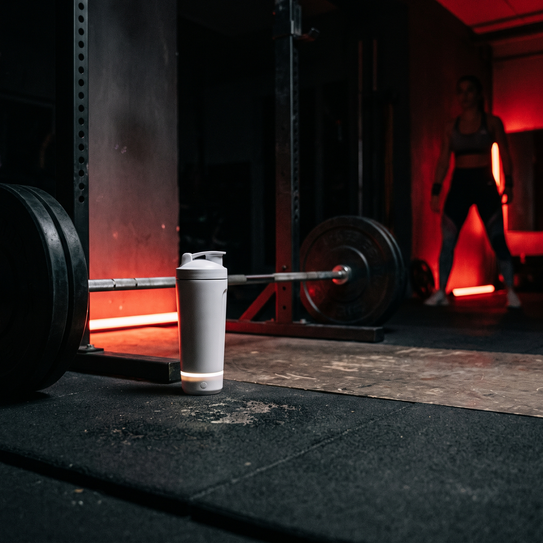 Electric Protein Shaker Bottle 650ml - White - gym floor with barbell rack lifestyle shot