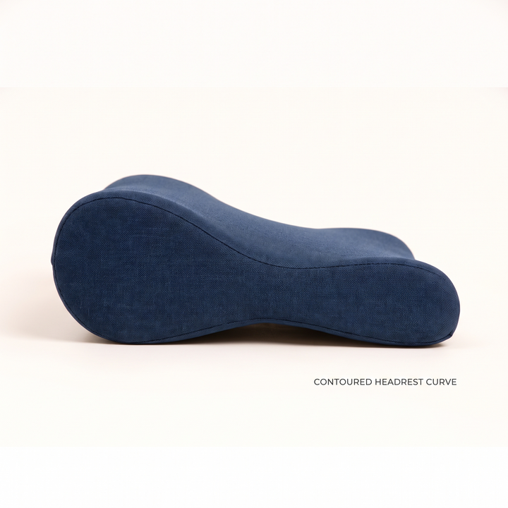 Contoured headrest curve of a navy blue massage table cushion