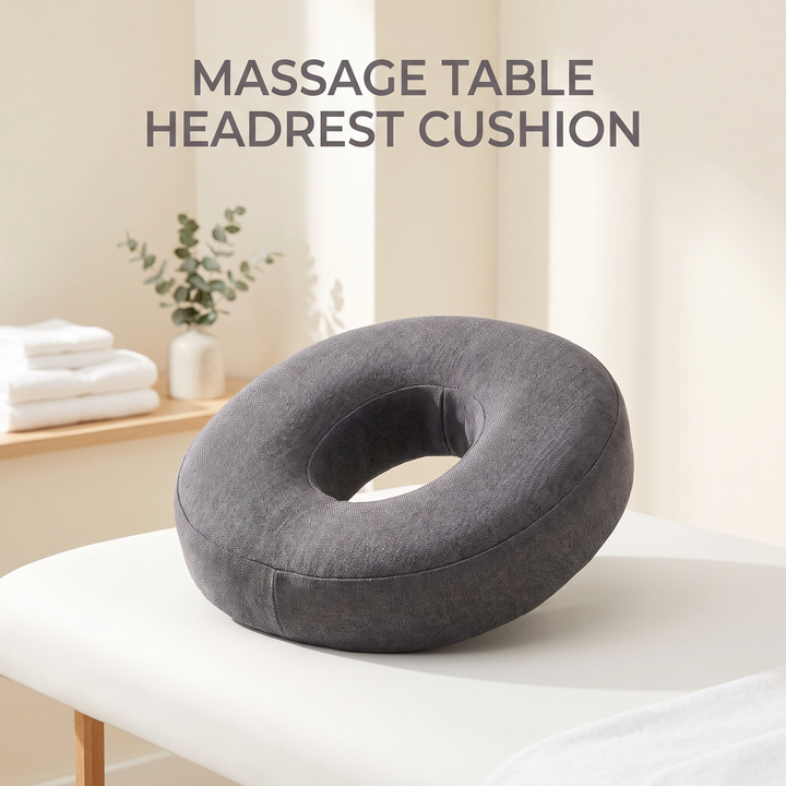 Gray ergonomic memory foam massage table headrest cushion in a spa treatment room