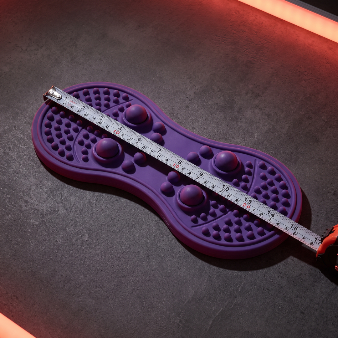 Purple foot massage board with tape measure showing dimensions