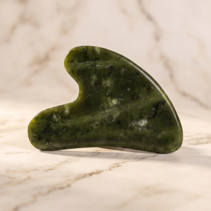 Heart-shaped natural jade gua sha facial and body massage tool, front view