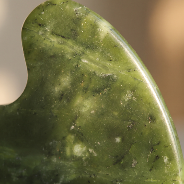 Macro close-up of natural jade stone texture and polish sheen
