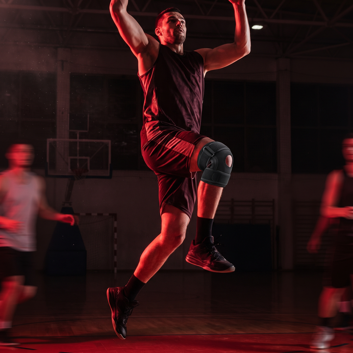 Athlete wearing black knee support strap during basketball jump shot