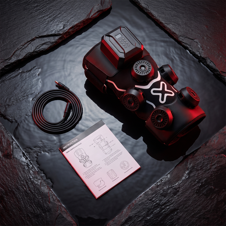 Flat lay of the knee recovery wrap with power cable and instruction booklet
