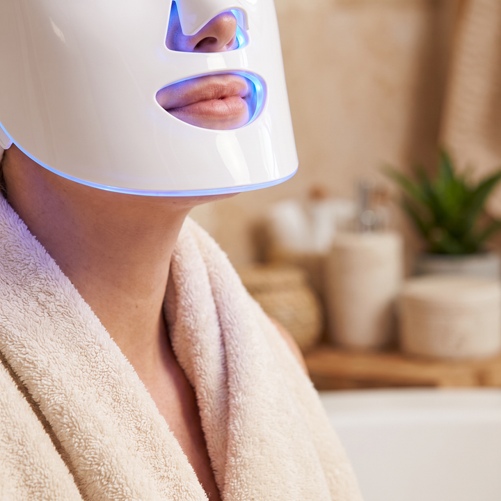 Close-up of the PHYSIOATHLETX LED Face &amp; Neck Light Therapy Mask in blue light mode