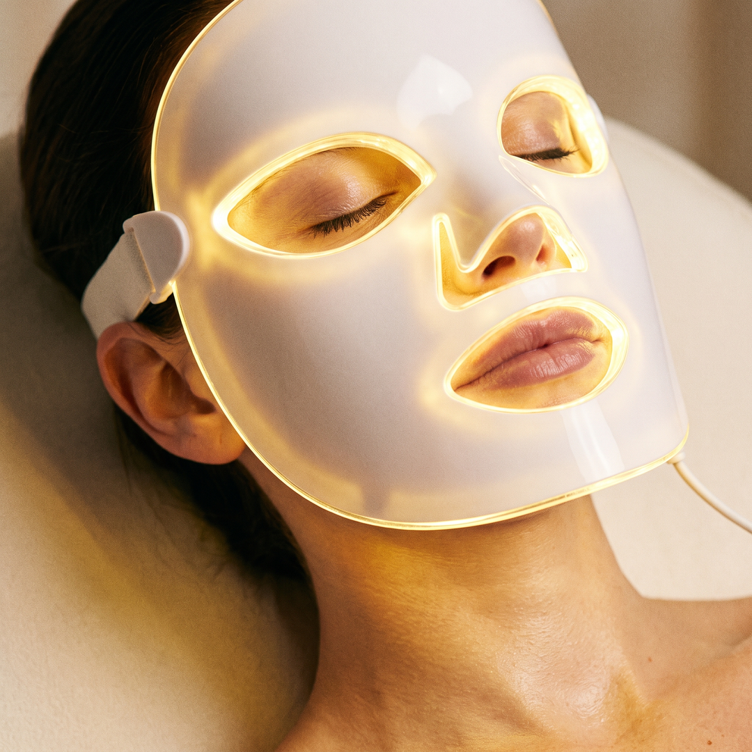 Close-up of the PHYSIOATHLETX LED Face &amp; Neck Light Therapy Mask in yellow light mode
