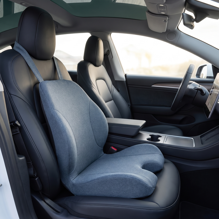 Ergonomic lumbar support seat cushion, blue gray, mounted on a car driver seat