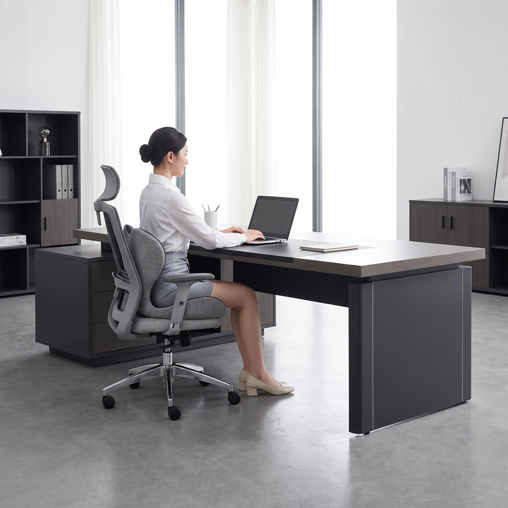 Person sitting with good posture in an office chair fitted with the ergonomic lumbar support seat cushion, mixed gray