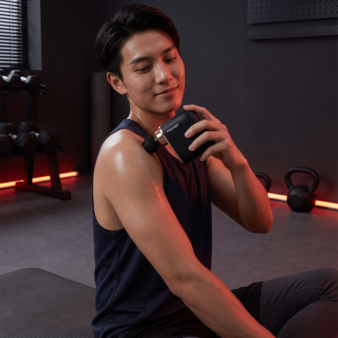 Mini massage gun used for post-workout home recovery