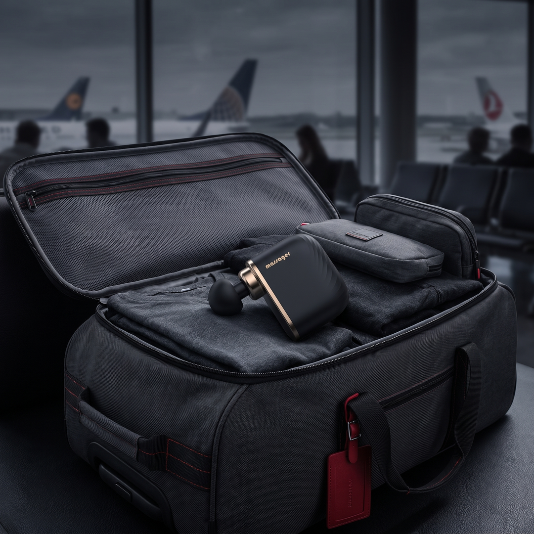 Mini massage gun packed for travel in carry-on bag