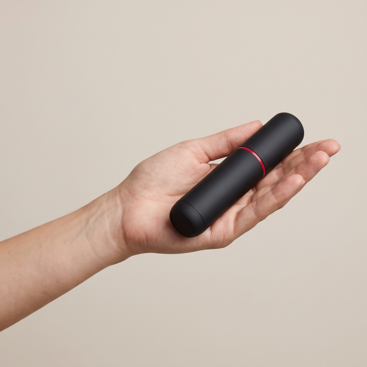 PHYSIOATHLETX handheld muscle relaxation pen held in hand for size reference