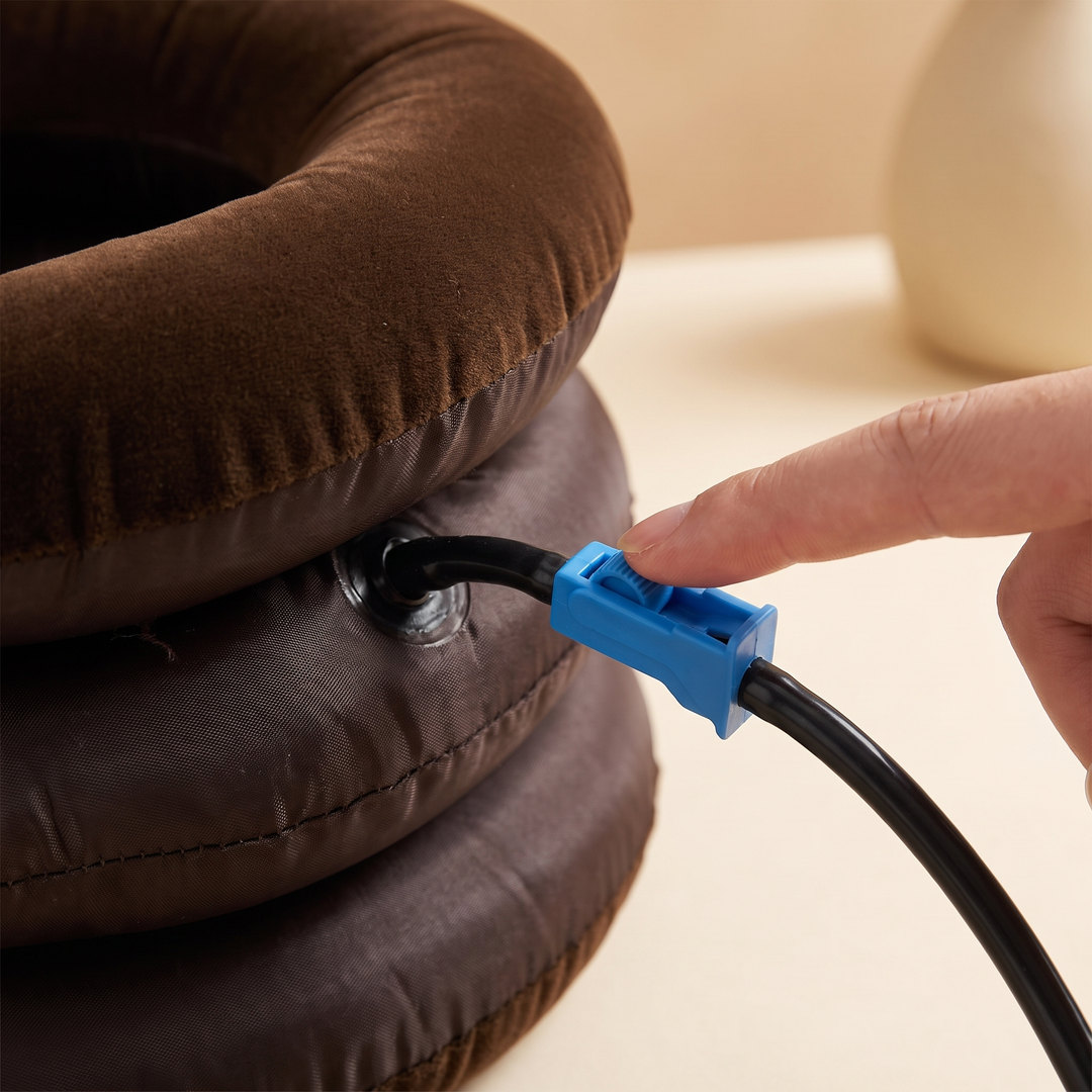 Close-up of the quick-release air valve on the brown neck relaxation cushion