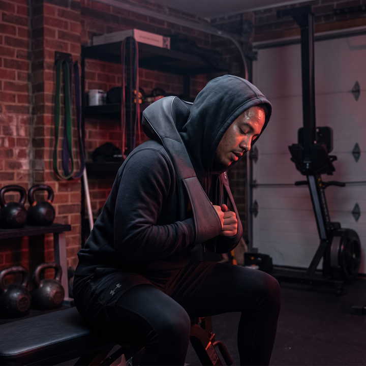Gray massager worn for post-workout recovery at home