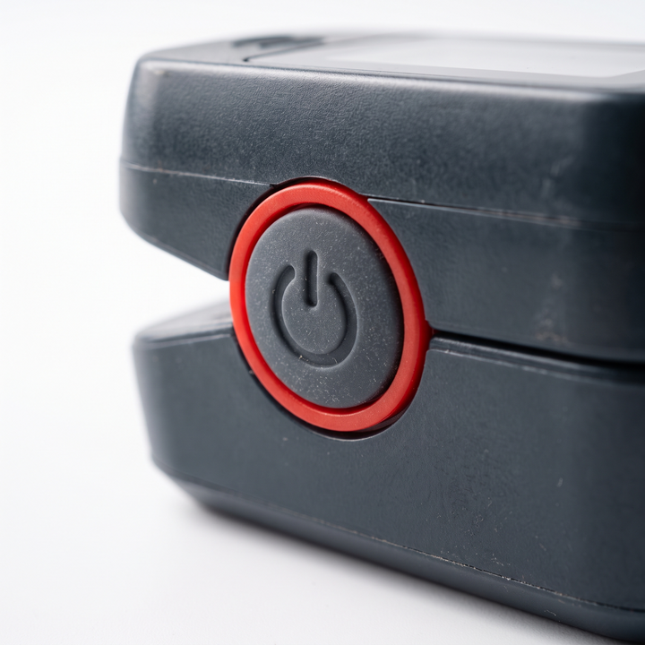 Close-up of the single-button power control on the finger pulse oximeter