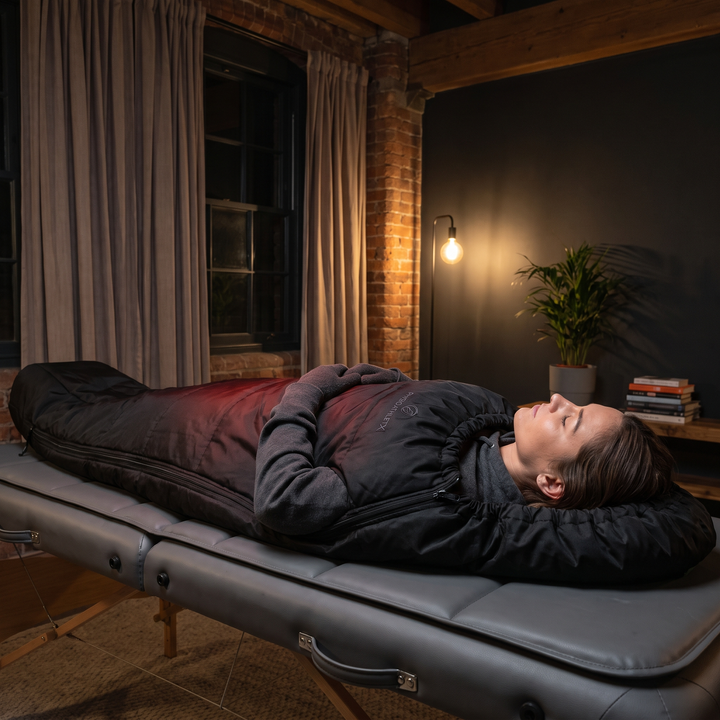 PHYSIOATHLETX Red Light Recovery Wrap - lifestyle person resting on recovery mat