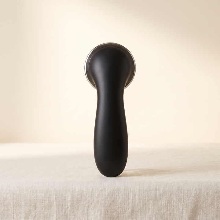 Black professional-grade skin massage device, front view, premium spa beauty tool