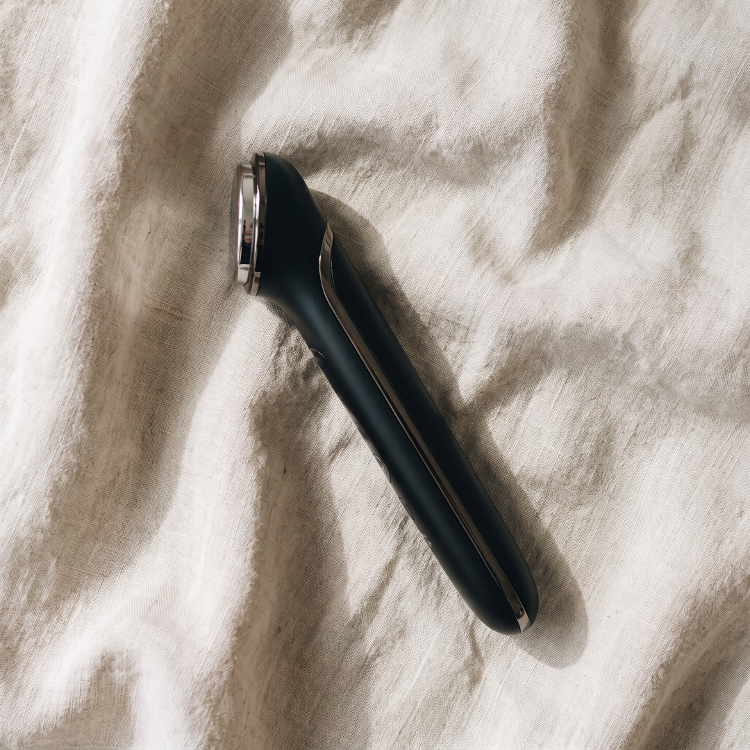 Black professional-grade skin massage device overhead product view