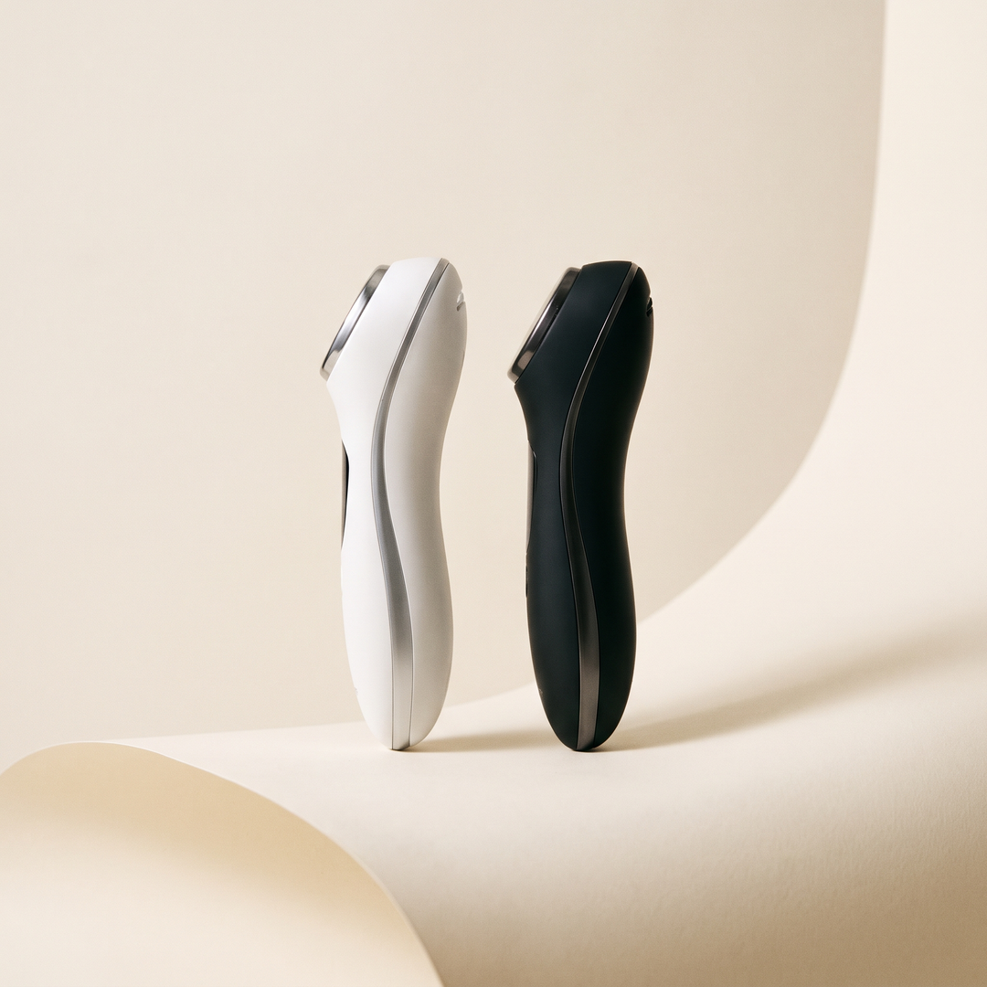 White and black professional-grade skin massage devices shown together, both color options