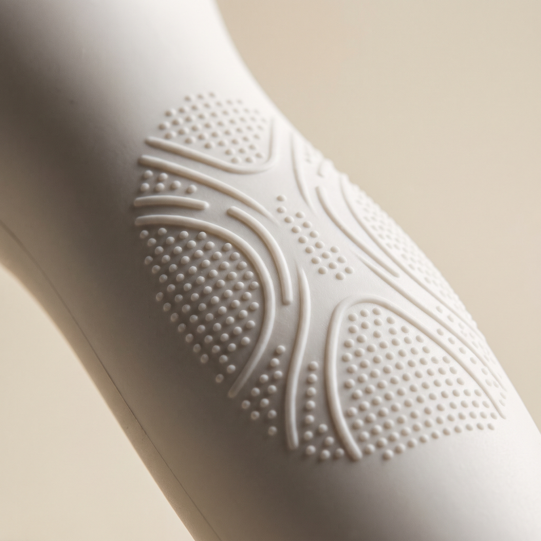 Close-up of white skin massage device ergonomic grip