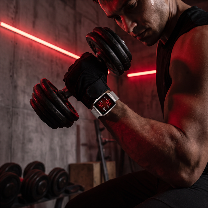 Athlete training in gym wearing PHYSIOATHLETX Smart Watch tracking heart rate during workout