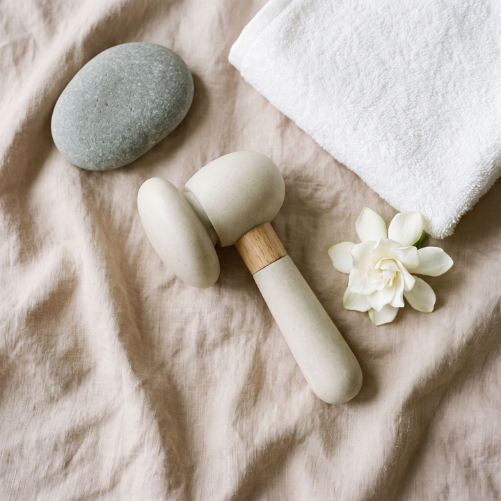 PHYSIOATHLETX spa device styled with calming spa props for a relaxing home ritual