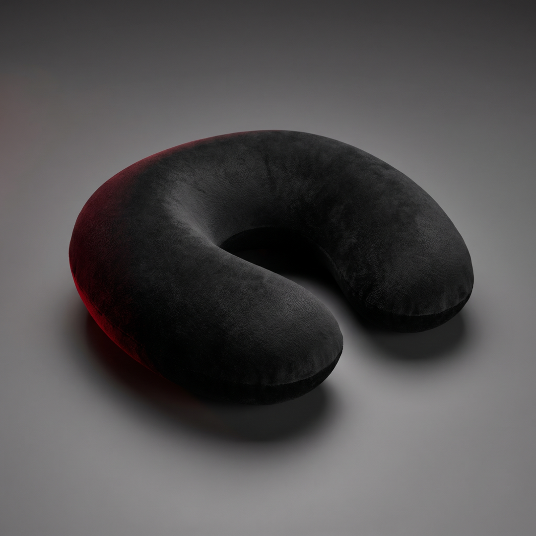 Black memory foam travel neck pillow at an angle showing ergonomic U-shaped support