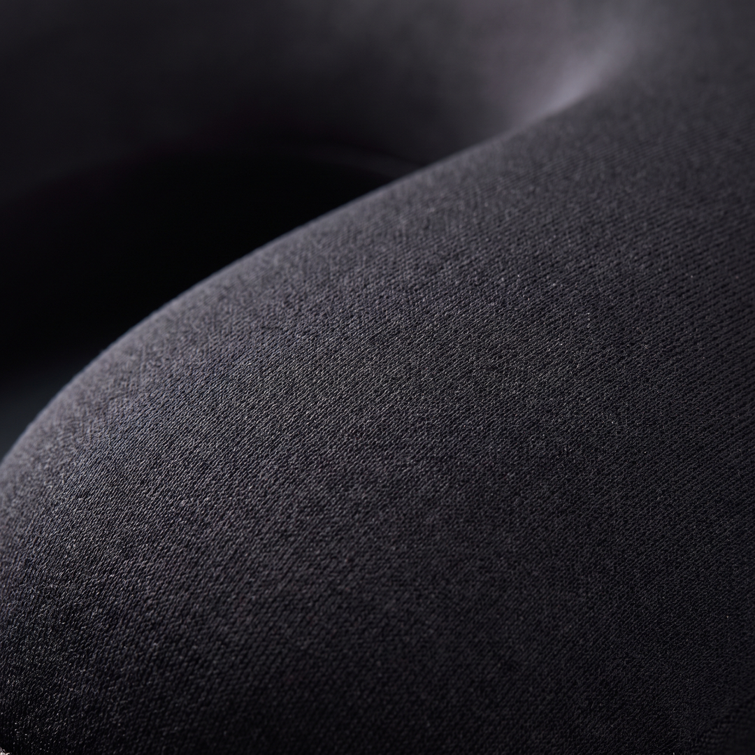 Close-up of breathable soft-touch fabric on the black travel comfort pillow