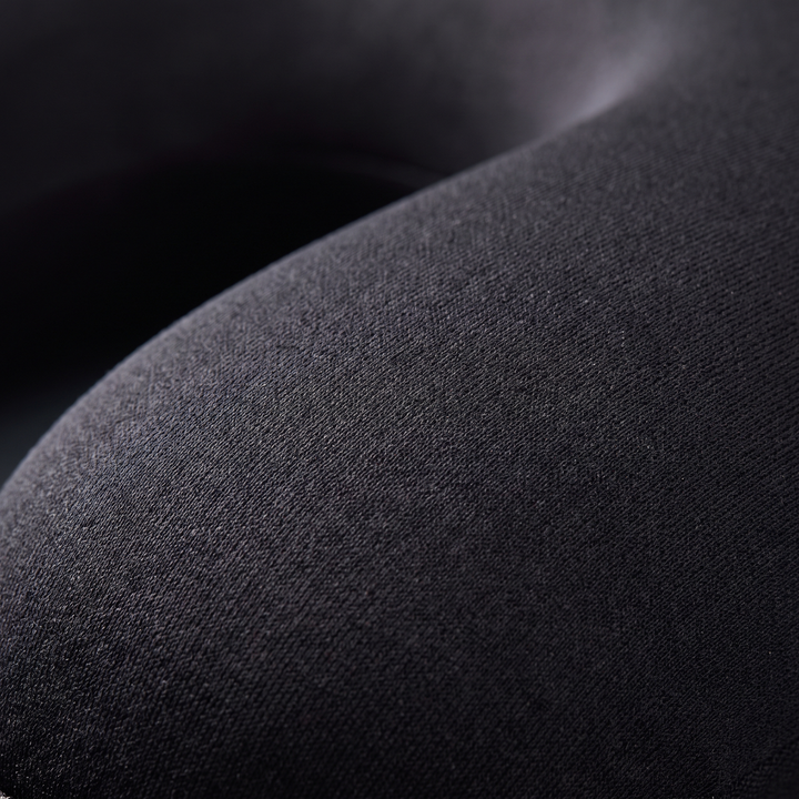 Close-up of breathable soft-touch fabric on the black travel comfort pillow