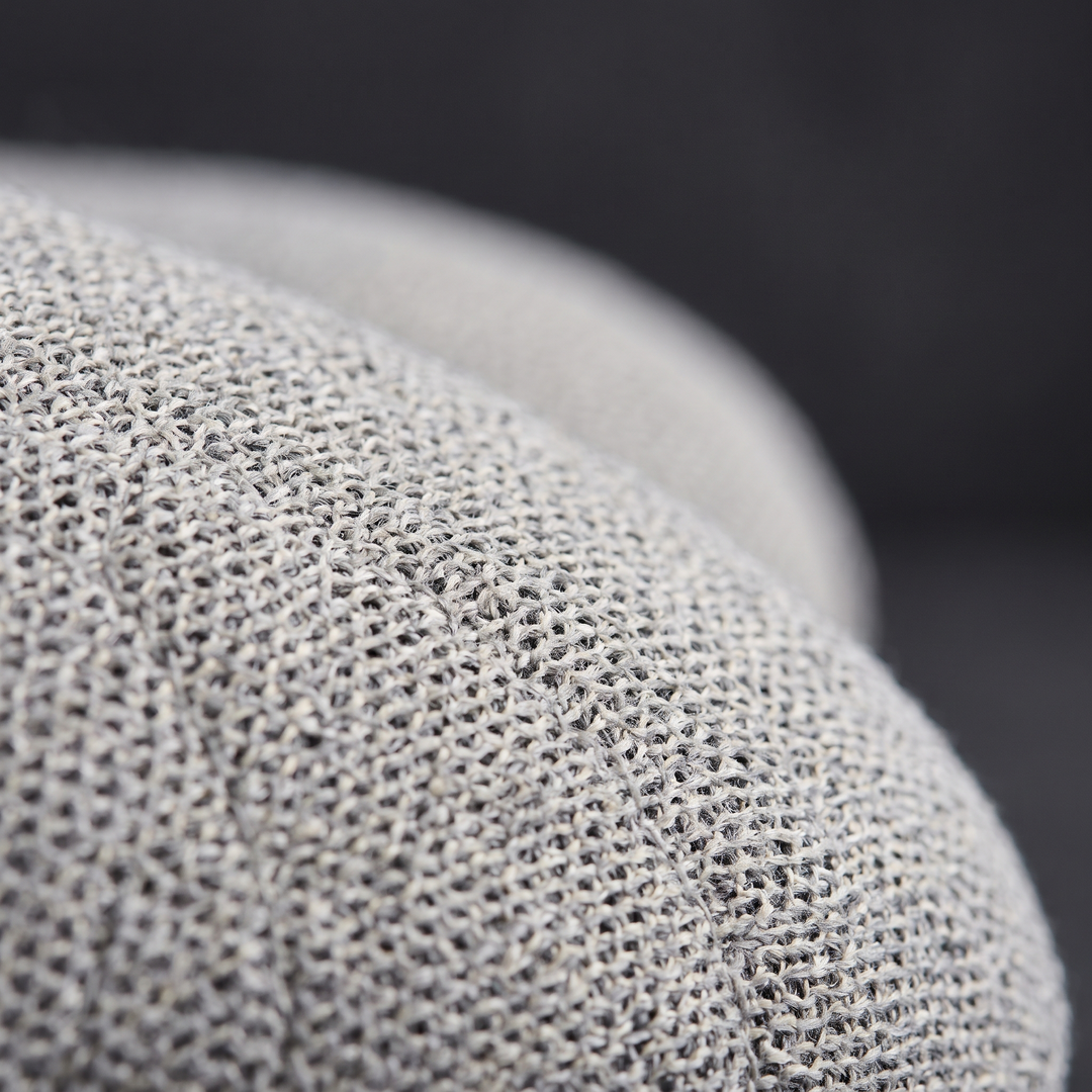 Close-up of breathable soft-touch fabric on the light grey travel comfort pillow