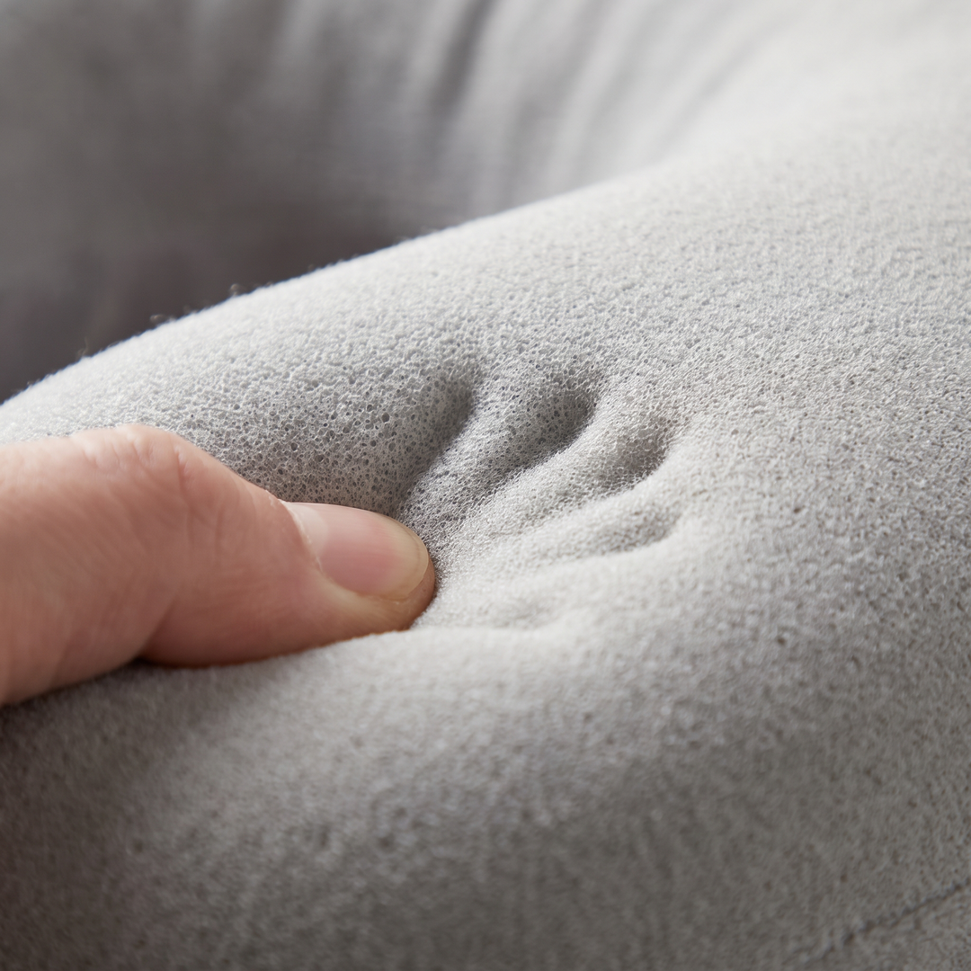 Close-up of memory foam contour comfort texture on the light grey travel neck pillow